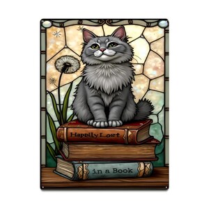 May include: A decorative metal sign featuring a gray cat sitting atop a stack of books. The books are labeled "Happily Lost" and "in a Book." The background resembles a stained-glass window with a dandelion.