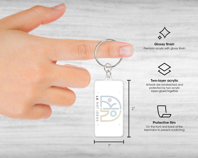 May include: A rectangular keychain with a glossy finish, featuring the text "LK ART IDEAS" and a graphic design. The keychain is 1 inch wide and 2 inches tall. It has a two-layer acrylic design and a protective film.