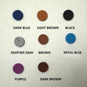 May include: Nine felt circles in various colors, including dark blue, light brown, black, heather gray, brown, royal blue, purple, and dark brown.