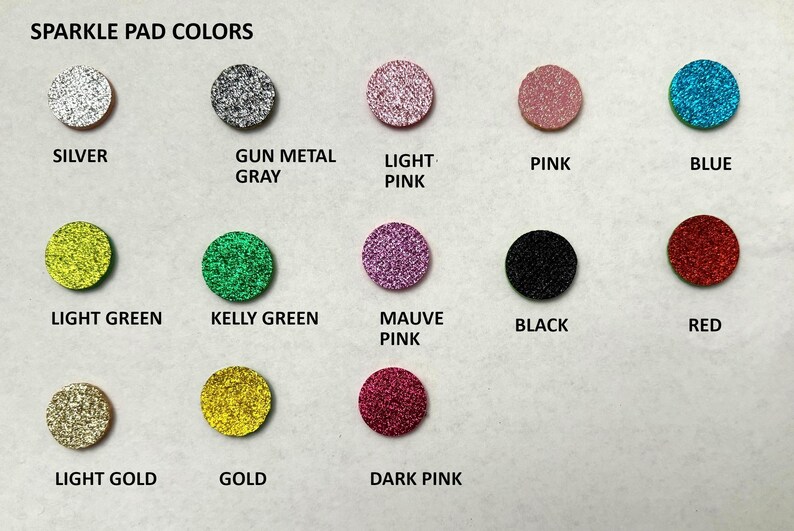 May include: A chart showing 12 different colors of sparkle pad material. The colors are silver, gun metal gray, light pink, pink, blue, light green, kelly green, mauve pink, black, red, light gold, and dark pink.