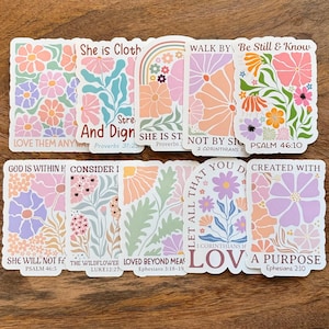 May include: A collection of floral stickers in pastel colors, featuring various designs with inspirational quotes and Bible verses. The stickers showcase flowers, rainbows, and botanical elements, perfect for journaling or decorating.