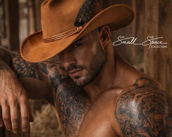 May include: A tan felt cowboy hat featuring a braided hatband and a dark feather with a geometric pattern. The hat is worn by a person with extensive arm and chest tattoos, paired with blue denim jeans and a brown leather belt with a metal buckle.
