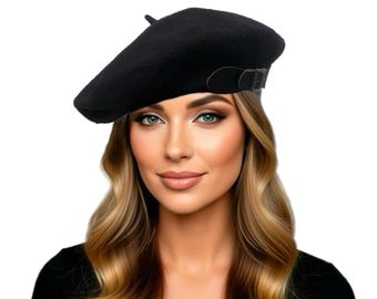May include: A black beret featuring a small black strap and a metal buckle on the side. The text Small Space COLLECTIONS is printed above the beret in a black script and sans-serif font. The beret has a small fabric tab at the top center.
