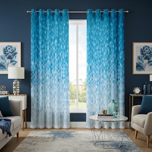 May include: A pair of blue and white geometric patterned curtains with grommet tops hanging in a living room with a window, a coffee table, and furniture.