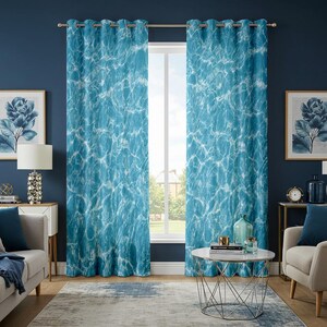May include: A pair of blue curtains with a water-like pattern, hanging from a silver rod. The curtains feature a design of white and light blue swirls, creating a flowing, aquatic effect. The curtains are in a room with a window, artwork, and furniture.
