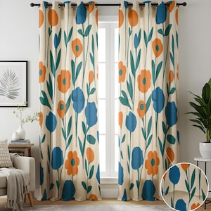 May include: Floral patterned curtain panels. The curtains feature a cream background with a repeating pattern of orange and blue flowers with green stems and leaves. The curtains are hung on a black rod.