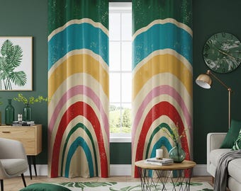 May include: A pair of green, yellow, red, blue, and pink rainbow patterned curtains with grommets. The curtains are hanging in a living room with a green wall, a window, a couch, a coffee table, and a plant.