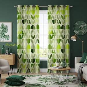 May include: A pair of green and white patterned curtains with geometric shapes and leaf designs. The curtains are hung on a window with a view of trees and a house in the distance.