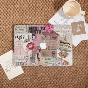 May include: A clear laptop case decorated with a collage of magazine clippings, including Vogue, lipstick, and the text "Breakfast at Tiffany's." The case also features the Apple logo and "Vivienne Westwood Accessories."