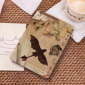 May include: A rectangular mousepad featuring a dragon graphic with the text "All we know about you... Is Wrong." The design includes maps and the text "How to Train Your Dragon."