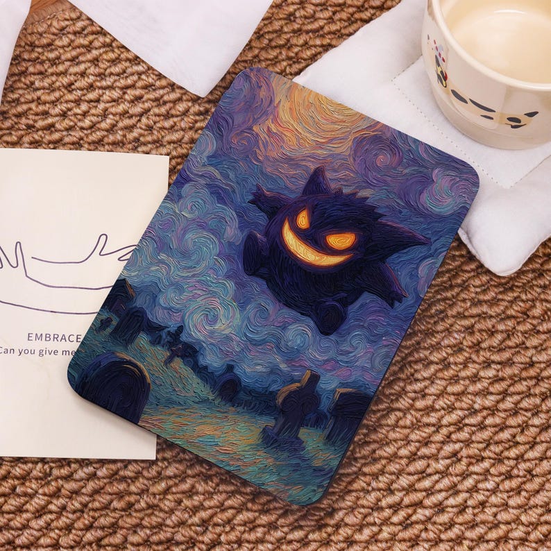 May include: Rectangular art print featuring a purple cartoon ghost with a glowing orange grin, set against a swirling night sky and a graveyard scene. The print has a textured, painted appearance. Text on a card reads "EMBRACE Can you give me".