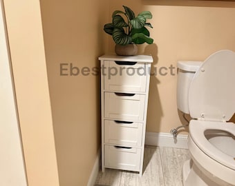 May include: A tall, narrow white storage cabinet with four stacked drawers, each featuring a semi-circular cutout handle. A potted green plant with striped leaves sits on top of the unit. The text Ebestproduct is visible on the wall.