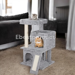 May include: A gray cat tree with multiple levels, a scratching post, and a ramp. Two cats are present, one gray and one orange tabby. The cat tree has the text "Ebestproduct" on the side.