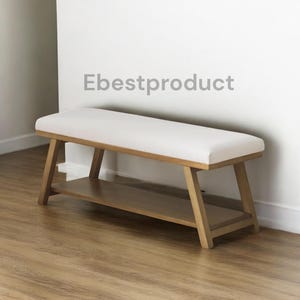 May include: A wooden bench with a white cushioned seat and a lower shelf. The bench has a light brown wooden frame and is placed against a white wall. The text "Ebestproduct" is visible on the wall.