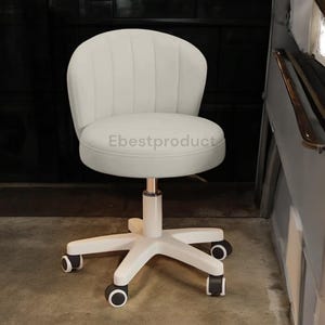 May include: A white, adjustable height office chair with a rounded back and seat. The chair has a five-point base with rolling casters. The backrest features vertical stitching. The text "Ebestproduct" is printed on the seat.