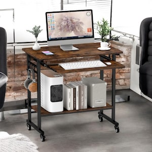 May include: A brown wooden computer desk with a black metal frame and wheels. The desk has a lower shelf for storage and a pull-out keyboard tray. A computer monitor, keyboard, and other office supplies are on the desk.