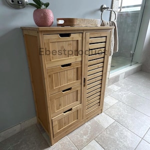 May include: A light brown bamboo storage cabinet featuring four stacked drawers with cutout handles on the left and a single vertical door with horizontal slats on the right. The cabinet has a natural wood grain finish and a rectangular shape.