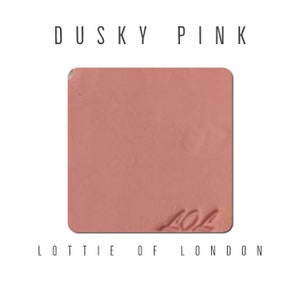 May include: A square sample of Dusky Pink lipstick from Lottie London, with the number 404 printed on the surface.