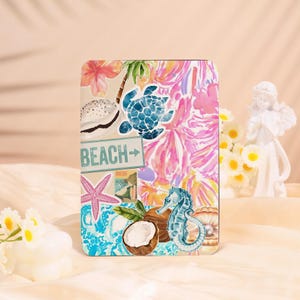 May include: A rectangular case featuring a beach-themed design. The case has a vibrant pattern of pink and yellow flowers, a blue turtle, a seahorse, and a starfish. The word "BEACH" is printed on the case.
