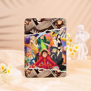 May include: A rectangular phone case featuring a colorful anime-style illustration of multiple characters. The design includes wanted posters with text like "DEAD OR ALIVE" and character names. The dominant colors are red, yellow, and blue.