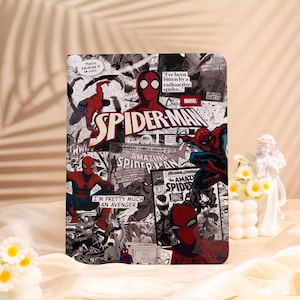 May include: A rectangular Spider-Man themed item featuring comic book panels in red, black, white, and blue. The design includes the Spider-Man logo and various action poses of the superhero. Text includes "Amazing Spider-Man" and "I'm pretty much an Avenger."