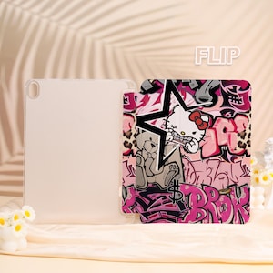 May include: A clear tablet case and a pink and black tablet cover with a graffiti-style design. The cover features a star, the text "BROK", and a cartoon cat character. The word "FLIP" is in the upper right corner.