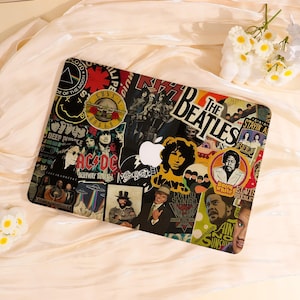 May include: A laptop with a colorful sticker design featuring various rock bands such as The Beatles, AC/DC, and Guns N' Roses. The design includes band logos, album art, and portraits, creating a collage effect. The laptop has a white Apple logo.
