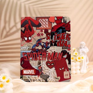 May include: A rectangular Spider-Man themed item featuring a collage of comic book art. The design includes images of Spider-Man in various poses, the word "SPIDER-MAN" in bold letters, and the Marvel logo. The color scheme is predominantly red, blue, and black.
