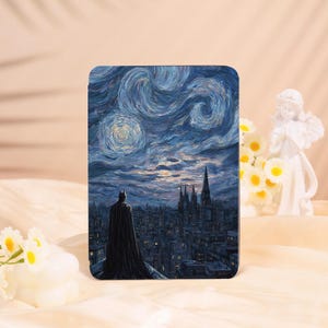 May include: A rectangular case featuring a painting of Batman overlooking a city under a swirling, starry night sky. The artwork is reminiscent of Van Gogh's style, with dark blues and yellows dominating the color palette. The case has a matte finish.
