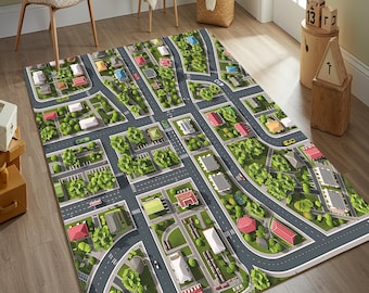 May include: A rectangular area rug featuring a detailed aerial view of a suburban neighborhood with gray roads, green patches of grass, various houses with red and white roofs, and small toy cars scattered throughout the street layout.