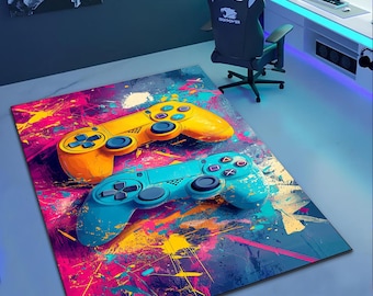 May include: A colorful rug with a blue and yellow video game controller design. The rug has a blue, pink, yellow, and white abstract paint splatter design.