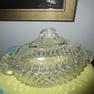 May include: A clear glass covered dish with a diamond pattern and a knob on the lid.