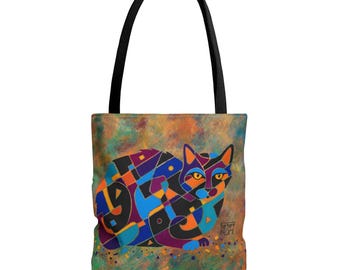May include: A tote bag with a black handle and a colorful cat design. The cat is depicted in geometric shapes with shades of blue, orange, purple, and black. The background has a mottled, abstract appearance with green, orange, and brown hues.