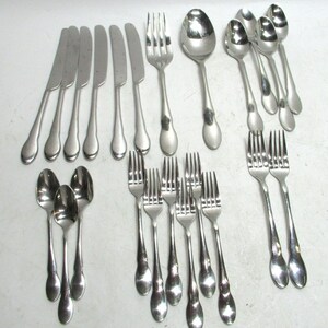 May include: A collection of stainless steel silverware, including knives, forks, and spoons. The silverware has a simple, elegant design with rounded handles. The arrangement includes multiple place settings, ideal for a dinner party or everyday use.