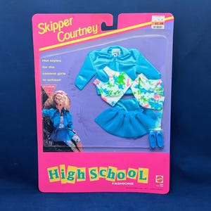 May include: A Skipper Courtney High School Fashions doll clothing set in original packaging. Includes a bright blue jacket, a white tank top with a multi-colored paint splatter print, a matching patterned skirt, a blue tulle skirt, and blue shoes.