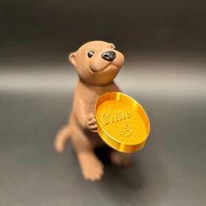 Gold dish

A cute otter-shaped jewelry holder with a trinket dish, available in multiple colors for added charm.