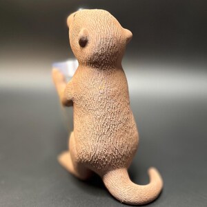A cute otter-shaped jewelry holder with a trinket dish, available in multiple colors for added charm.