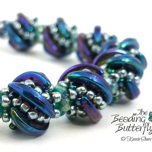 May include: A blue and silver beaded bracelet with a swirling design. The bracelet is made with iridescent glass beads and silver seed beads. The bracelet is called "Whirligig".