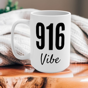 May include: White ceramic mug with a black graphic that says "916 Vibe".