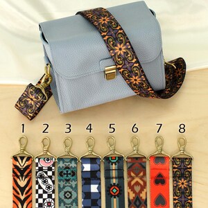 May include: Eight different colorful patterned straps for a bag. The straps are numbered 1 through 8. The straps are made of fabric and have a gold metal clasp.