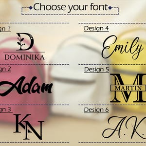 May include: A font selection chart for personalized backpacks featuring six distinct black text designs labeled Design 1 through Design 6. The options include names like Dominika, Adam, Emily, Martin, and initials KN and A.K. in various styles.