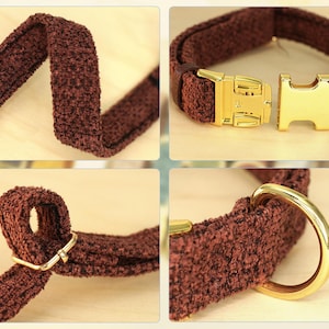 May include: A brown dog collar with a textured fabric. The collar features a gold-colored metal buckle and a matching D-ring for leash attachment. The collar is designed for comfort and style.