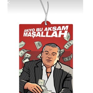 May include: Red rectangular air freshener with an illustration of a man in a suit surrounded by falling money. The text "AKIYO BU AKŞAM MAŞALLAH" is printed in white on the top.