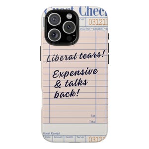 May include: A phone case featuring a design resembling a guest receipt. The case has a light pink background with blue grid lines and text that reads "Liberal tears! Expensive & talks back!" The top of the case has a camera lens.