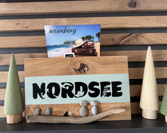 A maritime-themed oak card holder. North Sea Plotter lettering and beach finds. Scandinavian design.