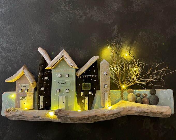 Maritime cottages, houses, and wooden houses in winter. Illuminated and decorated with North Sea driftwood and Baltic Sea beach finds. Christmas decorations.