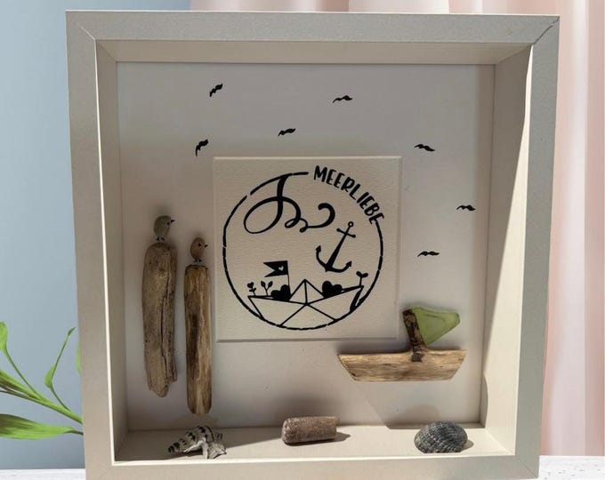 A maritime stone picture featuring Baltic Sea beach finds lovingly arranged in a picture frame. A plotter gift featuring North Sea driftwood.