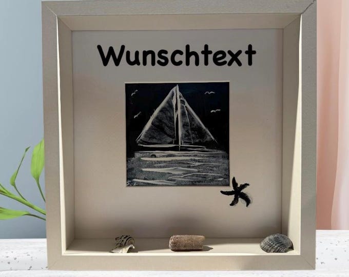 Maritime decoration with a hand-painted sailboat. Individually decorated with North Sea and Baltic Sea beach finds. 3D picture frame.
