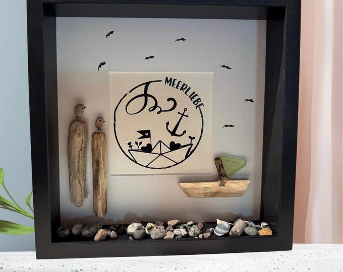 A maritime stone picture featuring Baltic Sea beach finds lovingly arranged in a picture frame. A plotter gift featuring North Sea driftwood.