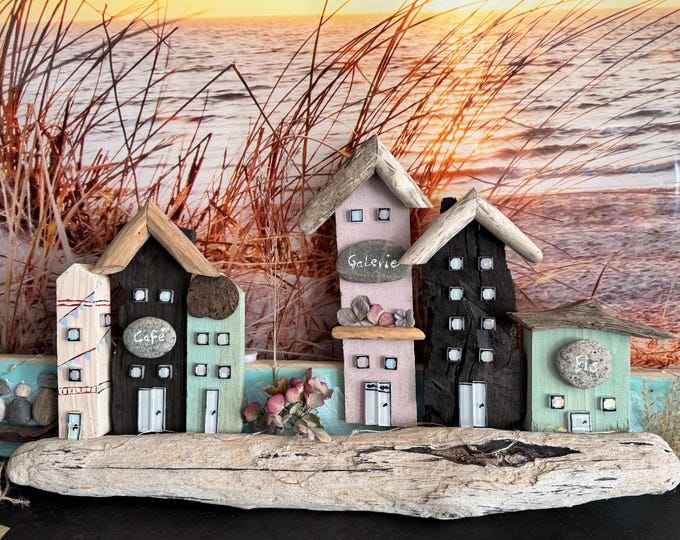 Maritime Scandinavian wooden houses on driftwood from the North Sea. Mural decorated with beach finds from the Baltic Sea.